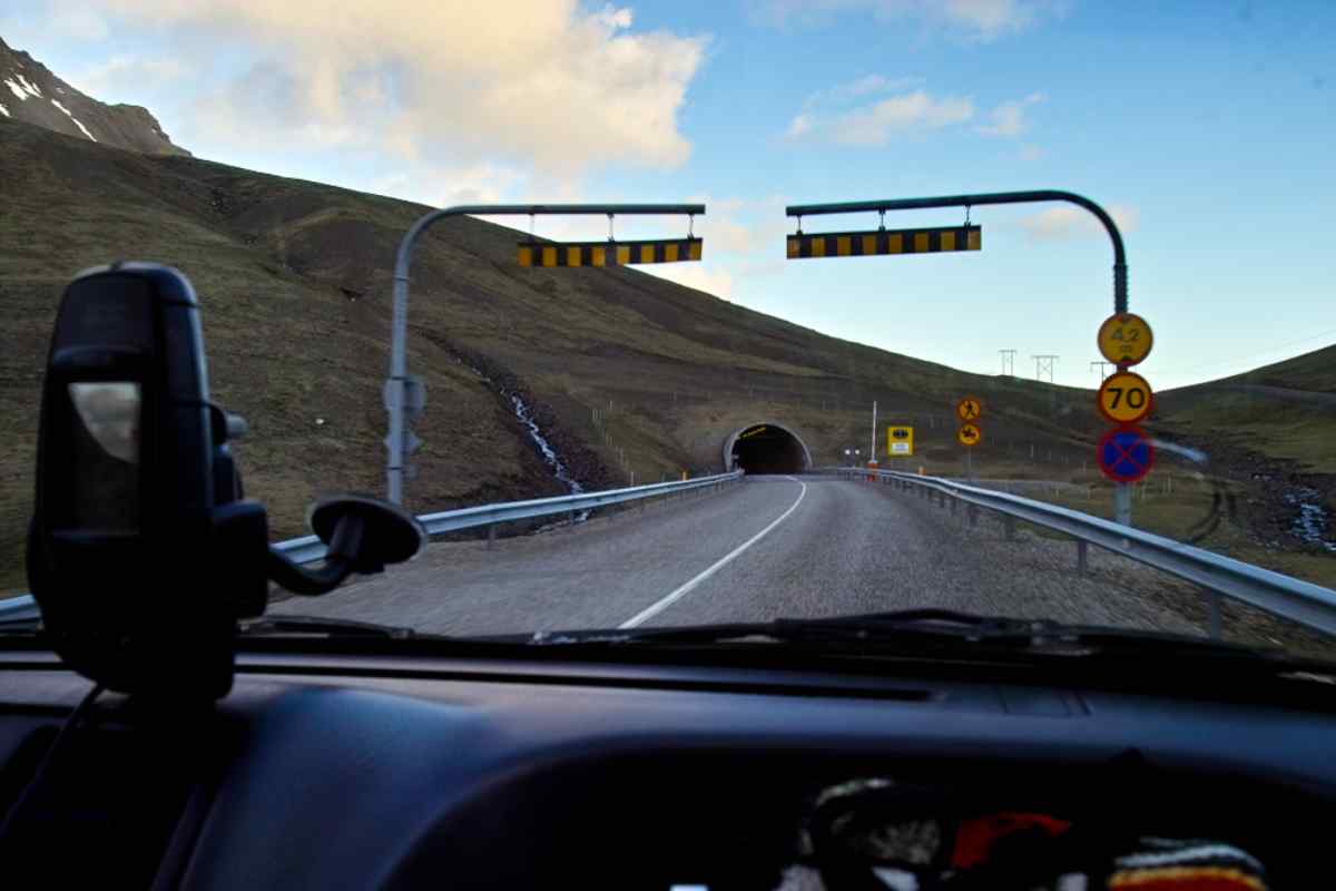 View from inside a moving car of the entrance to the Almannaskarðsgöng tunnel in Iceland.