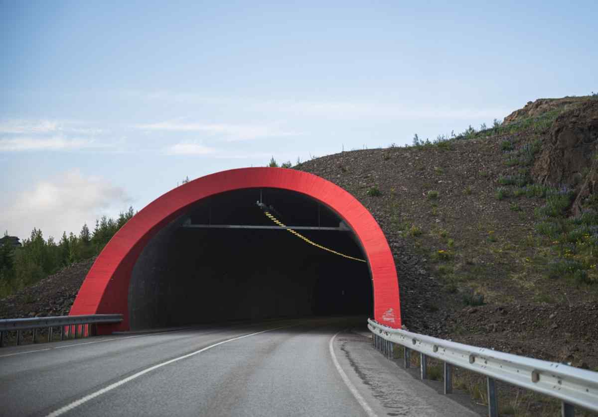 General view of the entrance to Iceland's Vaðlaheiði Tunnel with its unique red frame.