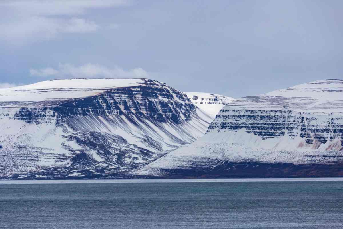Drangajökull Glacier: Majestic snow-covered peaks in Iceland's Westfjords Snow-covered mountains of Drangajökull glacier in the Westfjords of Iceland, viewed from across the water