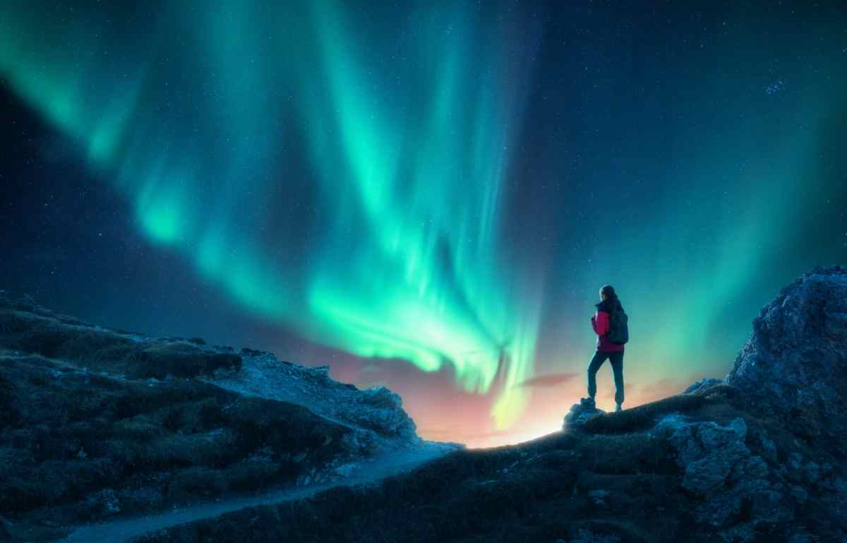 tourist watching the northern lights in Iceland in October
