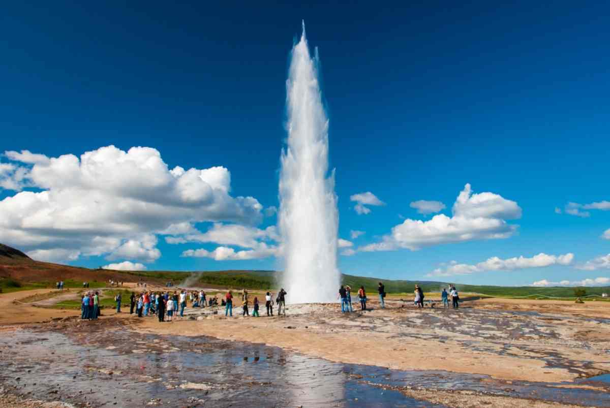 Strokkur geysir gushing water into the air