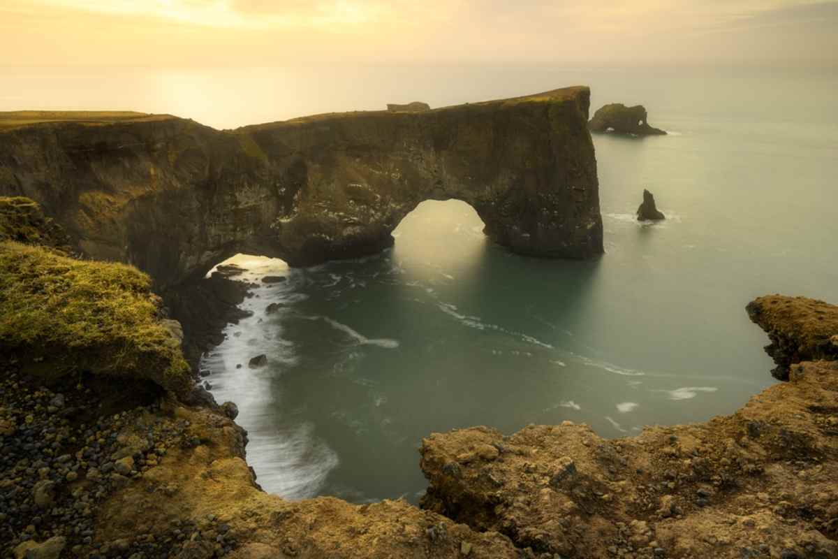 Dyrholaey arch by a black sand beach