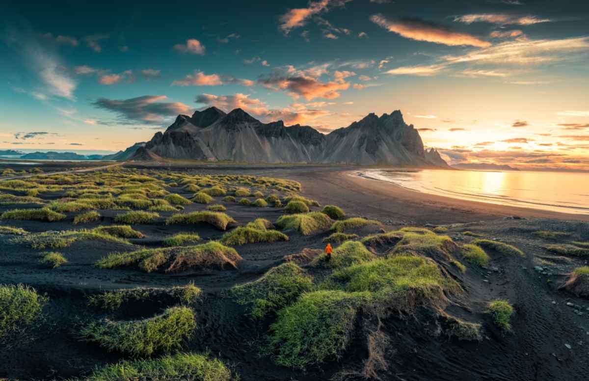 unrise over Vestrahorn mountain with clump of grass