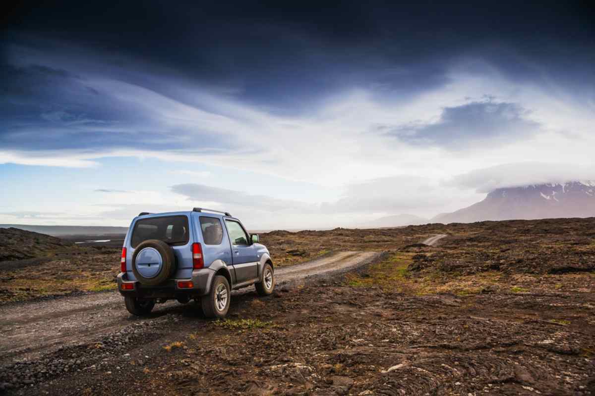 General view of a 4x4 vehicle driving on a Golden Circle Icelandic road.