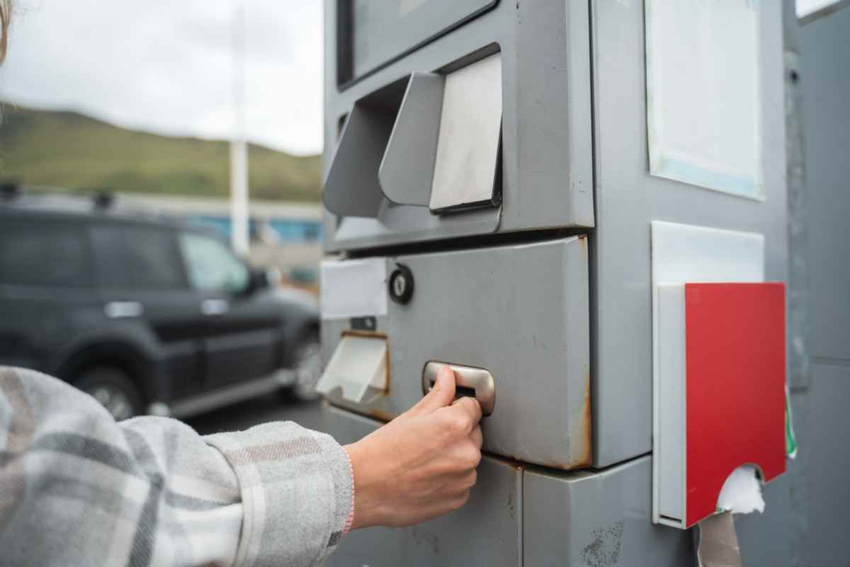 Person inserting a card at a self-service fuel payment machine in Iceland.