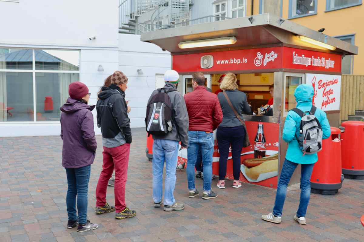 People lining up at B&aelig;jarins Beztu Pylsur, the famous Reykjavik hot dog stand, on a cool day in the city center.